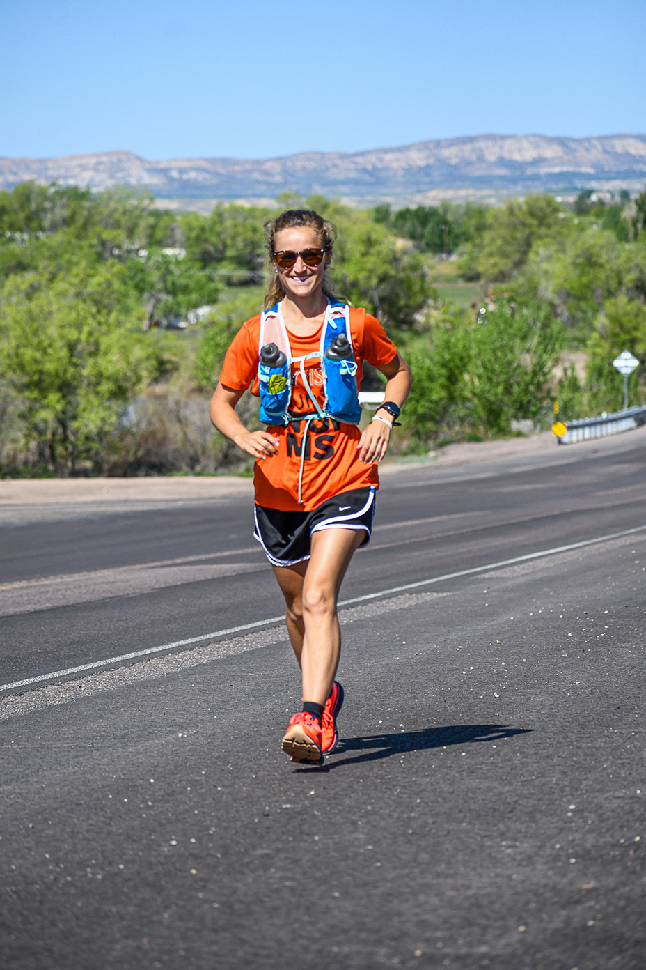 Meghan Guhler 鈥�16 running on road with mountains behind her