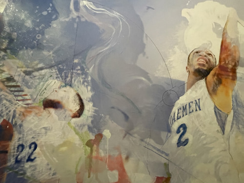 Two daemen mens basketball players with numbers 22 and 2 on their jerseys, swirling blue and whites behind them